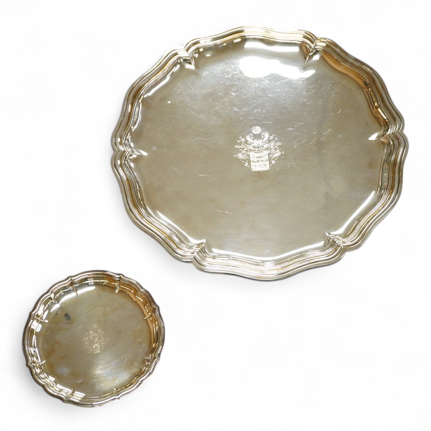 A German 800 standard white metal salver, diameter 35.9cm, together with a similar waiter, diameter 15.6cm, both with engraved armorial, 35oz.